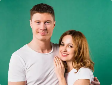 portrait-smiling-young-couple-against-green-background