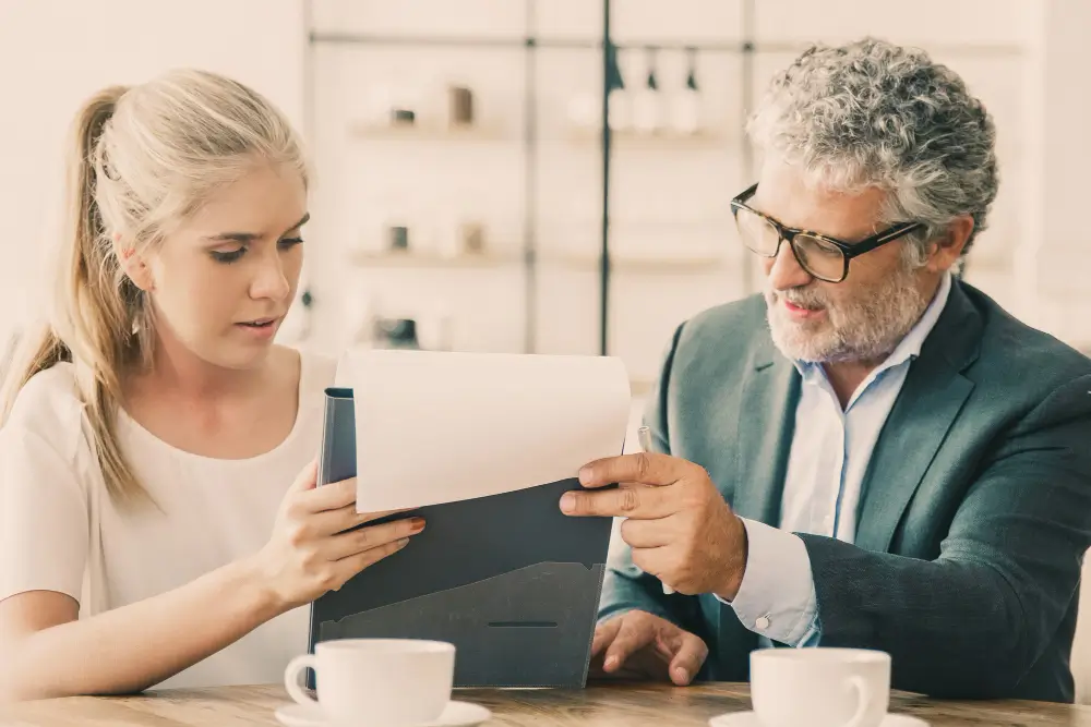 Protecting Inheritance from a Greedy Stepdaughter - A confident senior man in a lawyer’s office signing estate planning documents, while a stepdaughter looks on suspiciously in the background